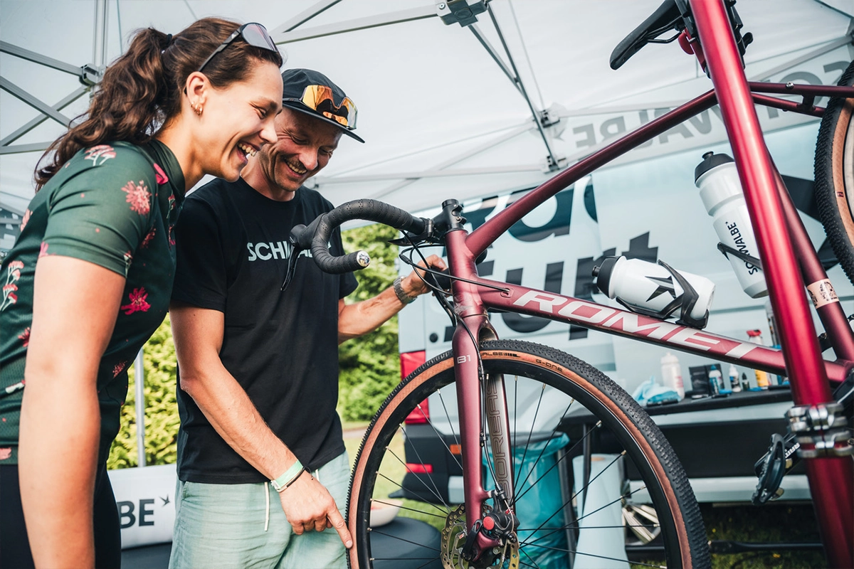 two people looking at a bicycle and smiling